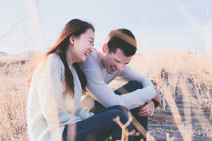 man and woman friends laughing